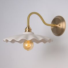 a wall light with an umbrella shade on the side and a bulb attached to it