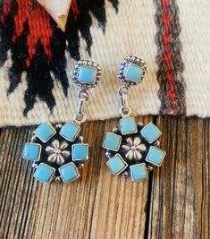 Lovely Handmade Turquoise and Sterling Silver Cluster Dangle Earrings. Such beautiful craftsmanship! These measure 1 7/8 inches long and 3/4 of an inch wide. Stamped Sterling and Nizhoni. *Non-Native* Thank you for checking out my store. Please contact us with any questions. Southwestern Blue Drop Earrings, Southwestern Blue Earrings For Pierced Ears, Southwestern Style Blue Earrings For Pierced Ears, Southwestern Style Blue Pierced Earrings, Southwestern Style Blue Drop Earrings, Turquoise Dangle Flower Earrings, Turquoise Flower Earrings, Fashion Earrings, Dangle Earrings