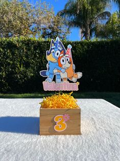 an image of a birthday cake with cartoon characters on it and the number three in front