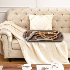 a tray that has beads on it sitting on a couch