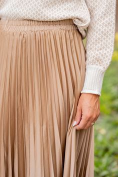 We cannot get over how stylish this skirt is! The cinched waist and accordion accents makes this such a cute, elegant look! Wear this skirt to any event and you are sure to receive compliments! We love tucking a blouse into this for a more elevated look or a basic or graphic tee for a casual feel!97% Polyester & 3% SpandexHand wash cold. Color separate. Do not bleach. Lay flat to dry. Low iron if needed. Pleated Tiered Mini Skirt With Relaxed Fit, Chic Beige Stretch Pleated Skirt, Chic Stretch Beige Pleated Skirt, Elegant Beige Tiered Skirt Bottoms, Spring Midi Pleated Skirt With Elastic Waistband, Elegant Beige Tiered Mini Skirt, Chic Accordion Pleats Mini Skirt For Fall, Spring Flared Pleated Skirt With Elastic Waistband, Spring Voluminous Pleated Skirt With Elastic Waistband