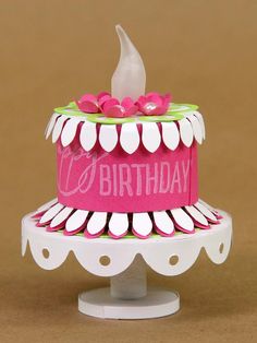 a birthday cake with pink and green decorations