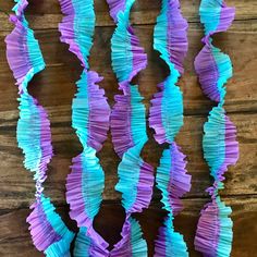 purple and blue paper streamers on a wooden surface