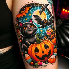 a woman's leg with a halloween themed tattoo on it and a black cat