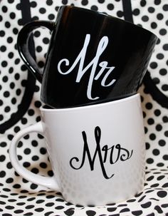 two black and white coffee mugs with mr and mrs written on them