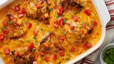 a casserole dish with meat, tomatoes and cheese on it next to a bowl of parsley