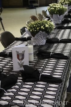 tables with black and white tablecloths are set up for an event