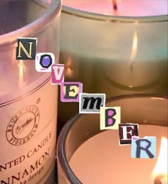 a candle that is sitting next to some letters