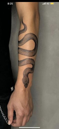 a man with a snake tattoo on his arm