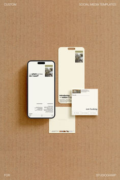 an iphone and business cards on top of a cardboard box