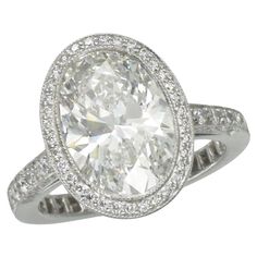 Tiffany & Co. Oval Diamond Engagement Ring. This diamond ring has a 4.00ct oval brilliant cut diamond center (Color: F, Clarity: VVS2, GIA#21859869, Tiffany H05110692) in a diamond halo ring with diamonds halfway down the shank. Signed Tiffany & Co., H05110692, and numbered 23358409. Tiffany Diamond, Emerald Cut Diamond Ring, Oval Diamond Engagement, Oval Diamond Engagement Ring, Emerald Cut Diamond, Expensive Jewelry, Platinum Engagement Rings, Modern Ring, Tiffany And Co