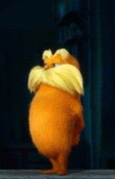 a large orange stuffed animal standing on its hind legs