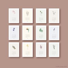 twelve calendars with flowers on them in different shapes and sizes, all lined up against a beige background