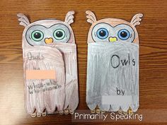 two owls made out of paper sitting on top of a wooden table