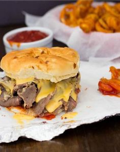 a cheeseburger with fries and ketchup on the side