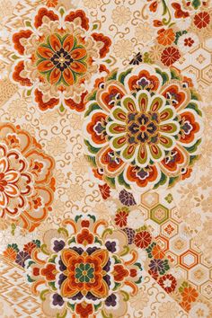 an orange and green floral pattern on fabric