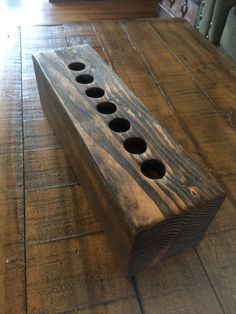 a wooden table with four holes in it