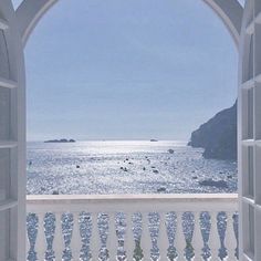 an open window looking out at the ocean