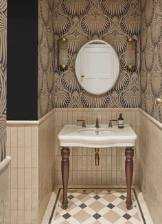 a white sink sitting under a mirror in a bathroom