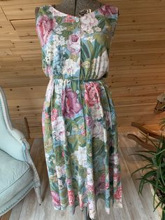 Lovely Vintage Carol Anderson California Sleeveless Maxi Dress. The tag says a size 9-10 but please use the measurements for correct size fit. It is a pretty floral pattern with buttons down the front, elastic waist (no belt) side pockets and side slits. It is in excellent condition with no flaws. Measurements Armpit to armpit 17.5” Waist 11” stretches to 20” (22-40) Hips Free Shoulder to hem 49” For updates, new products, one-of-a-kind's, special offers and more-like us on Facebook:https://www. Sleeveless Dress With Button Closure For Garden Party, Green Sleeveless Dress With Elastic Waistband, Botanical Pattern, Flowy Dress, Sleeveless Maxi Dress, Vintage Lighting, Flower Dresses, Vintage Floral, New Products