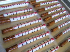 several sausages are lined up in rows on a baking sheet and ready to be cooked