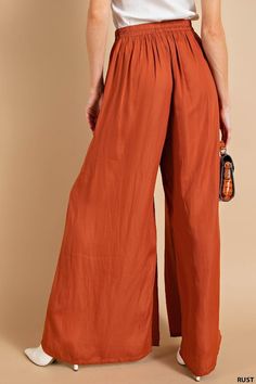 Description Add a touch of elegance (and comfort) to your wardrobe with our Blushing Satin Pants. Featuring a light weight, flowy fit and an elastic waistband, these pants are perfect for any occasion. And with convenient side pockets, you'll never have to leave anything behind. Rust never looked so good!" Specs Self: 100% Polyester Unlined Hand wash cold Do Not Bleach Hang dry Fits true to size - model is wearing a small S (0-4), M (6-8), L (10-12) SKU#: IS-003360 Please note that all online inventory reflects inventory in store. Chic Summer Pull-on Style Pants, Trendy Full Length Pants For Vacation, Trendy Full-length Pants For Vacation, Trendy Pants For Vacation, Solid Color Summer Wide-leg Parachute Pants, Solid Color Wide-leg Parachute Pants For Summer, Solid Wide-leg Parachute Pants For Summer, Versatile Rayon Bottoms With Pockets, Elegant Vacation Bottoms Solid Color