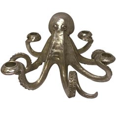 an octopus figurine with two candles in it's mouth and one on its back