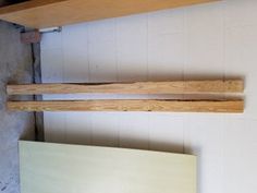 two wooden boards are hanging on the wall