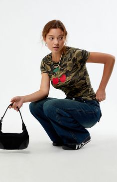 Add a playful edge to your wardrobe with the Camo Cherry Baby T-Shirt from PS / LA. Featuring a camouflage print paired with a cherry front graphic, this tee stands out with its short sleeves and crew neckline. The slightly cropped fit enhances its trendy appeal, making it a versatile piece for casual styling.Camo print baby teeShort sleevesCrew necklineCherry graphicCropped lengthFitted95% cotton, 5% spandexMachine washableModel is wearing a size smallModel measurements: 5’6.5” height, 32” bust, 23” waist, 35” hips PS / LA Womens Camo Cherry Baby T-Shirt - Camouflage Neutral size XS Cherry Baby, Womens Camo, Camouflage Print, Top Graphic Tees, Baby T Shirt, Camo Print, Baby Prints, Baby Tshirts, Pacsun