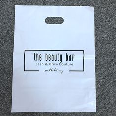 a white bag with the beauty bar logo on it