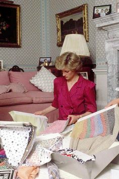 two women in a living room looking at fabric