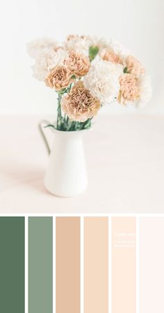 a white vase filled with flowers sitting on top of a table next to color swatches