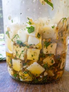 a jar filled with food sitting on top of a wooden table