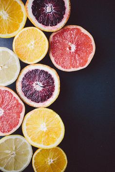 citrus fruit cut in half on black background