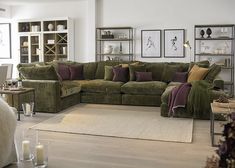 a living room filled with lots of furniture next to a white rug on top of a hard wood floor