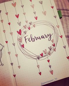 an open notebook with the word february written in cursive writing and hearts on it