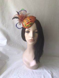 Looking for a African styled fascinator? This is an Ankara fascinator hat with orange, burgundy and touches of green, perfect for weddings, tea party, church hat, Kentucky derby hat or any other special occasions. Handmade and wrap with beautiful African print fabric and adorned with feathers and burnt orange with gold specs mesh. EASY TO WEAR Design to fit to the curve of the head and is flexible to bend and customized to your unique shape head. As with most of my headpieces, this hat can be wo Ankara Fascinator, Juneteenth Celebration, African Headwrap, Red Fascinator, Large Brim Hat, Types Of Hats, Church Hat, Bridal Tea, African Heritage