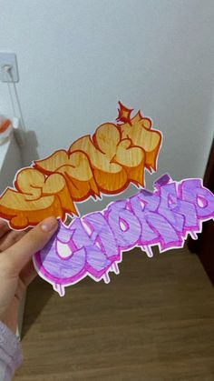 a person holding up a piece of paper with the word cookie on it