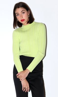 This lime green knit sweater features a high mock neck. Style it to your liking with any complementary colors or your favorite outerwear. Ribbed mock neck Fitted Long sleeves Turtleneck Self: 98% Polyester, 2% Spandex Length: 23 3/4" Chest: 13" Hand wash in cold water. Lay flat to dry. Model is wearing a size small Style #: G2210WT5825 Trendy Fitted Green Sweater, Green Fitted Casual Turtleneck, Trendy Spring Knit Turtleneck, Fitted Textured Knit Turtleneck With Funnel Neck, Fitted Yellow Turtleneck Sweater, Fitted Green Funnel Neck Top, Trendy Mock Neck Top For Spring, Green Ribbed Sweater For Work, Green Ribbed Sweater For Workwear