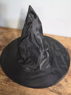 This is a costume party Halloween witch hat base that can be easily decorated or worn as is for a more classic witch look. Lightweight so ideal for lightweight decorations. THE PICTURES OF THE PREMADE HATS ARE FOR REFERENCE ONLY THEY ARE HATS I'VE MADE IN THE PAST. SO PLEASE DON'T EXPECT TO GET A PREMADE HAT. I added structure to the underside of the hat before decorating because this is a super lightweight hat. Approximately: 15 inches across the rim, 8 inches across center opening and 13 inche Black Witchy Wide Brim Costume Accessories, Spooky Hats For Halloween Costume Party, Halloween Costume Hat One Size Fits Most, Wide Brim Costume Accessories For Halloween Party, One Size Fits Most Halloween Costume Party Hat, Halloween Costume Hats And Headpieces One Size, Halloween Cosplay Costume Hats, Halloween Novelty Costume Hat With Wide Brim, Halloween Costume Hat With Wide Brim