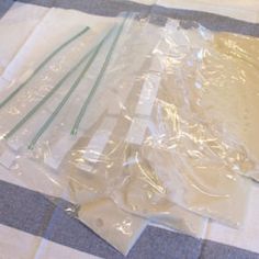 several pieces of clear plastic sitting on top of a blue and white checkered table cloth