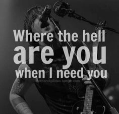 a man holding a guitar in front of a microphone with the words where the hell are you when i need you