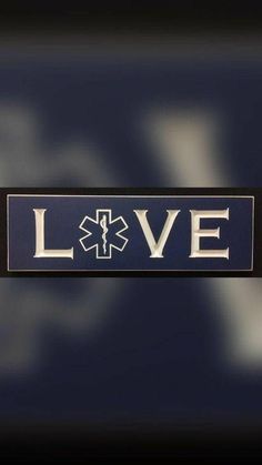 the word love is written in white on a blue background with an embossed medical symbol