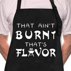 a man wearing an apron that says, that ain't burn that's flavor