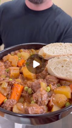 a man is holding a pan full of food