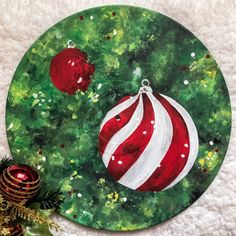 a painted christmas ornament with ornaments on it