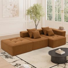 a living room filled with furniture and a tree in the corner on top of a rug