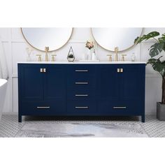 a bathroom vanity with two mirrors above it and a potted plant in the corner