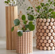 three wooden vases with plants in them