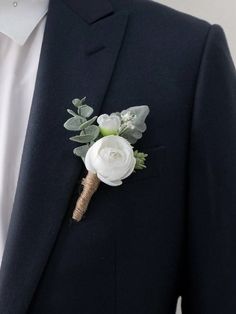 a man in a suit with a boutonniere on his lapel